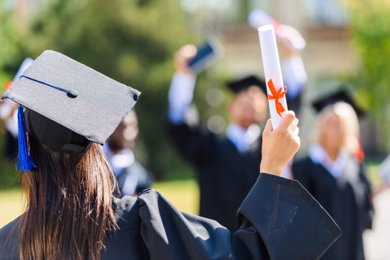 Eine Hochschul-Absolventin hält ihr Diplom in der Hand. Sinnbild für Supervision für Lehrkräfte, Erziehende, Padgog:innen, Dozent:innen, (Hoch-)Schullleitung und Verwaltungsmitarbeitende in den Bereichen Pädagogik und Bildung